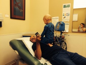 Sitting on Daddy. Best seat in the Doctor's office!